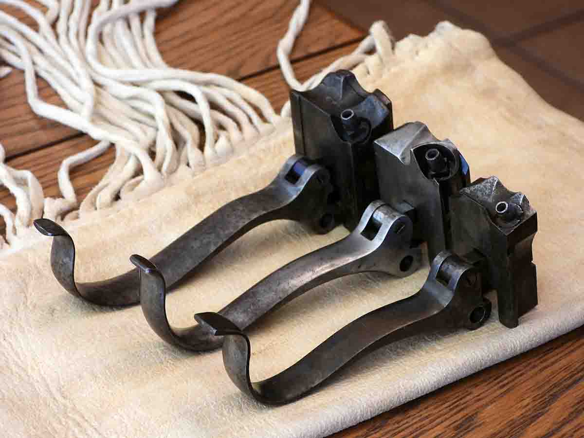 Overhead view of the Model 1851 block (bottom), the Model 1852 block (middle), and the New Model 1859 block (top).  Note how the size of the blocks and the sturdiness of the levers increased over time.  In addition, the top contour of the blocks and the nipple recesses were changed many times.